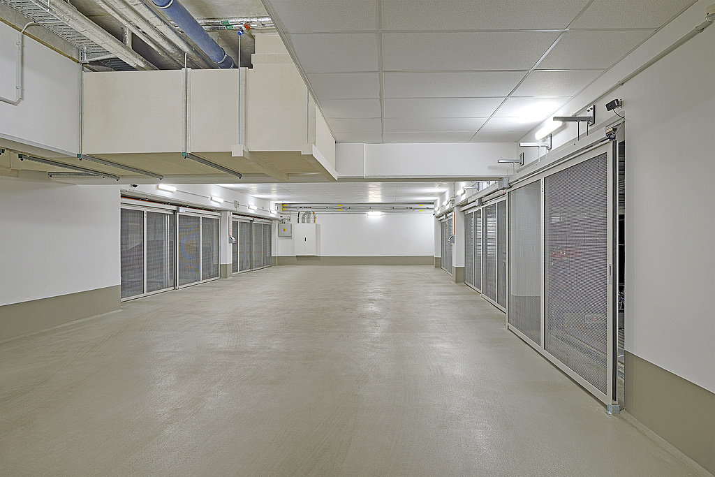 Manoeuvring area of an underground car park with wire mesh gates