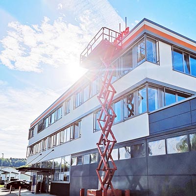 View of the company building with a lifting platform for assembly