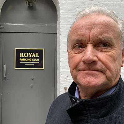 Man with entrance to the Royal Parking Club